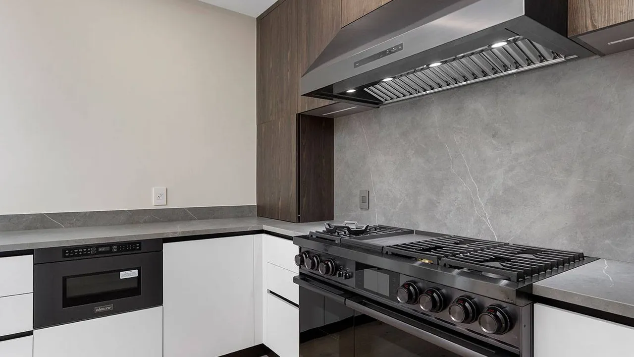Close up on a plate of mashed potatoes, topped with baked pork chops with cream of mushroom soup, and a side of green beans.