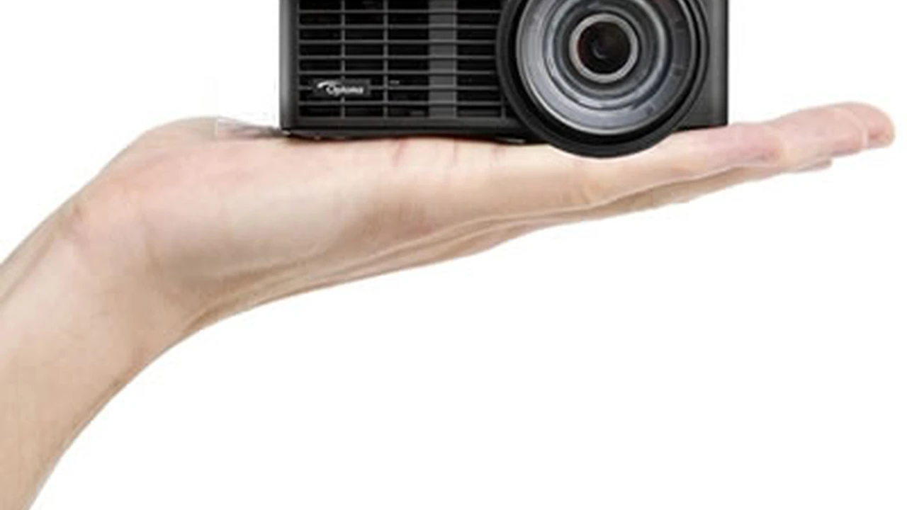 blue bowl of black bean beef tortilla soup on a board with cilantro and shredded cheese in background