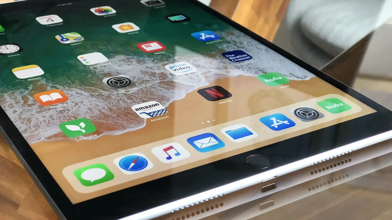 blue bowl of black bean beef tortilla soup on a board with cilantro and shredded cheese in background