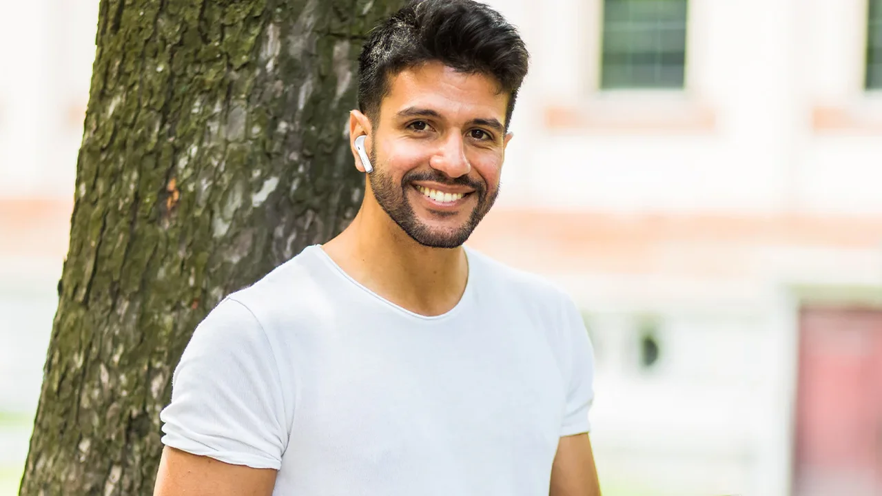 Close up on a plate of mashed potatoes, topped with baked pork chops with cream of mushroom soup, and a side of green beans.